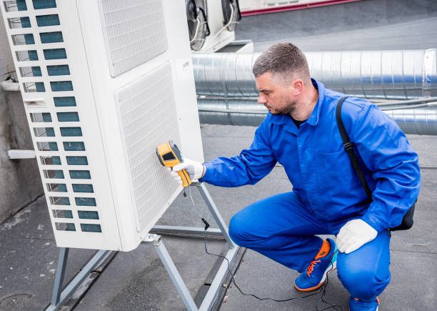 Technician uses a thermal imaging infrared thermometer to check the condensing unit heat exchanger