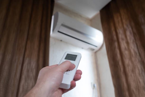 Split air conditioner on a wall. Turning on conditioner on summer day.