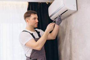 Technician performing high-quality aircon servicing on a wall-mounted unit