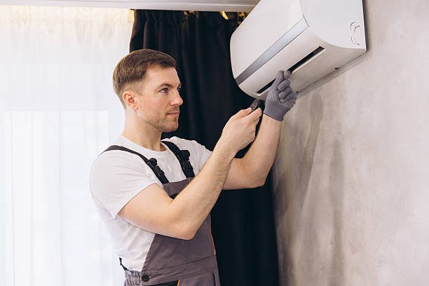 Technician performing high-quality aircon servicing on a wall-mounted unit